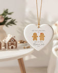 Heart-shaped ceramic ornament featuring a gingerbread man and woman with the text ‘Our First Christmas as Mr & Mrs’, personalised with couple’s names and year, hanging on a Christmas tree