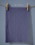 Deep navy tea towel with narrow vertical pink stitched stripes, giving a classic ticking-stripe look with a modern cottagecore twist.