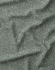 Sage green fabric with scattered abstract dewdrop marks, inspired by misty spring mornings in my Grandad’s garden.