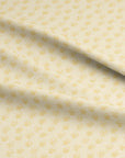 Cream fabric with soft yellow ditsy wildflower pattern, inspired by wild chervil from a spring garden