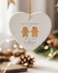 Personalised Mr & Mrs gingerbread couple ornament with wedding date and surname printed on a white heart-shaped ceramic bauble, styled in a cosy festive setting.