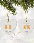 Two personalised Mr & Mr gingerbread couple heart ornaments hanging from gold cords on a pine branch. One shows first names (“Alex & James 2025”), and the other shows surname and wedding date (“Lawson 01.09.2025”). Soft festive bokeh background with text explaining customisation options below.