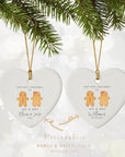 Set of two personalised Mr & Mrs gingerbread heart ornaments showing name and date options, displayed beneath Christmas greenery on a soft sparkling background