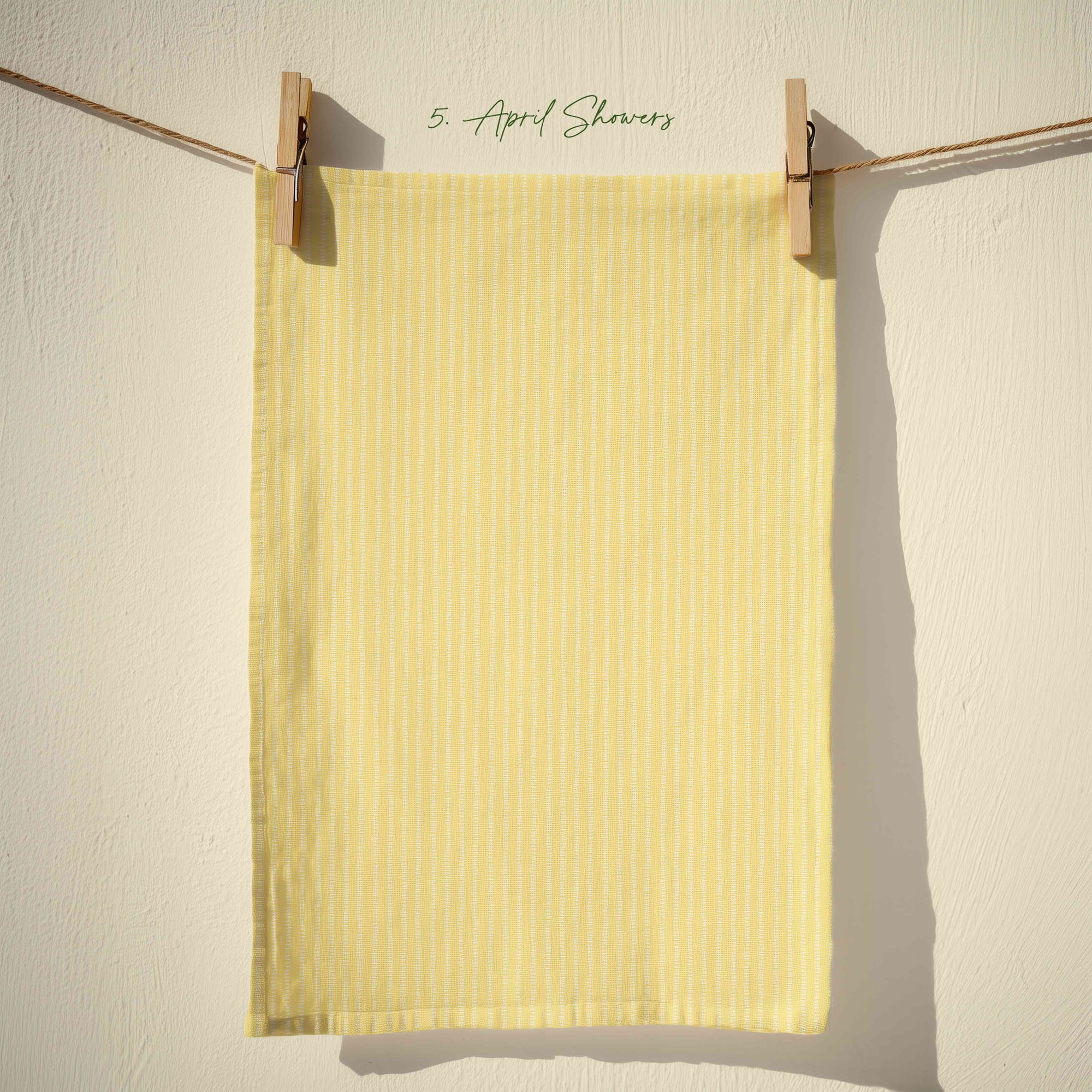 Soft yellow striped tea towel with fine vertical lines, inspired by sunshine and spring rain, minimalist cottage kitchen textile