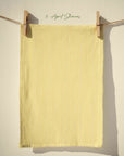 Soft yellow striped tea towel with fine vertical lines, inspired by sunshine and spring rain, minimalist cottage kitchen textile