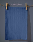 Deep navy blue striped tea towel with fine vertical dash lines, subtle rain-inspired pattern for farmhouse spring kitchens.