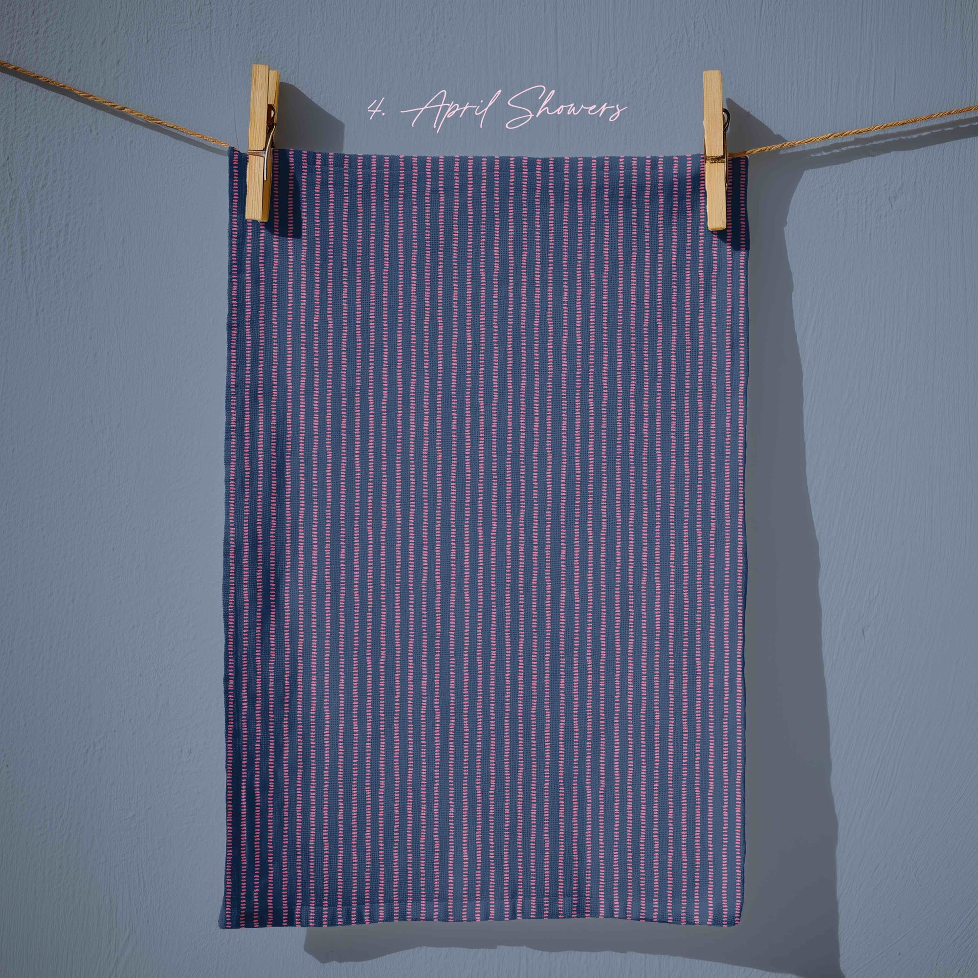 Deep navy tea towel with narrow vertical  pink stitched stripes, giving a classic ticking-stripe look with a modern cottagecore twist.