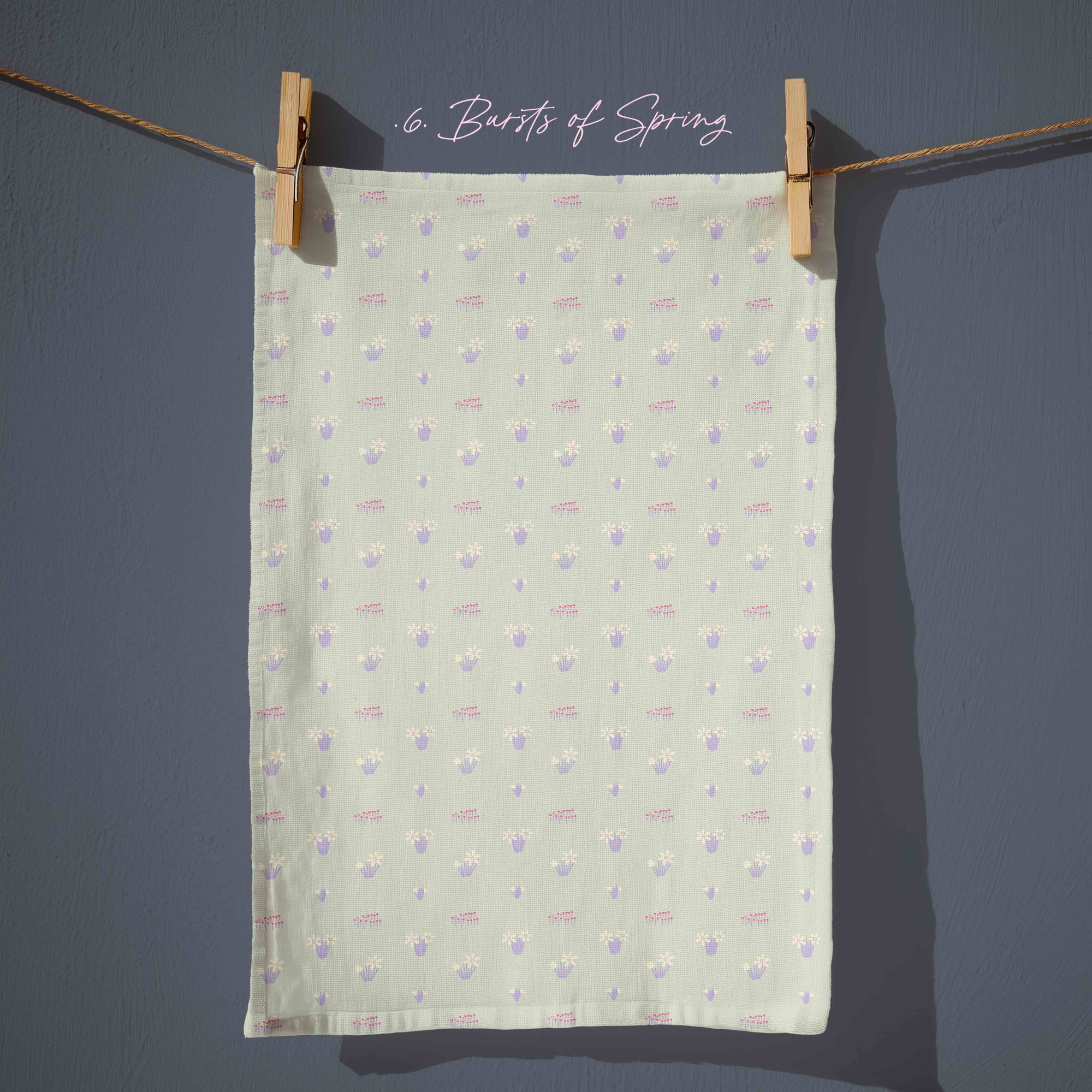 Soft sage green floral tea towel with small pastel daffodil motifs, gentle country garden pattern for spring cottage kitchens.