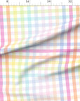 Large scale pastel rainbow gingham fabric shown flat against an inch ruler, with pink, lilac, blue, mint, lemon and peach checks on a white ground.