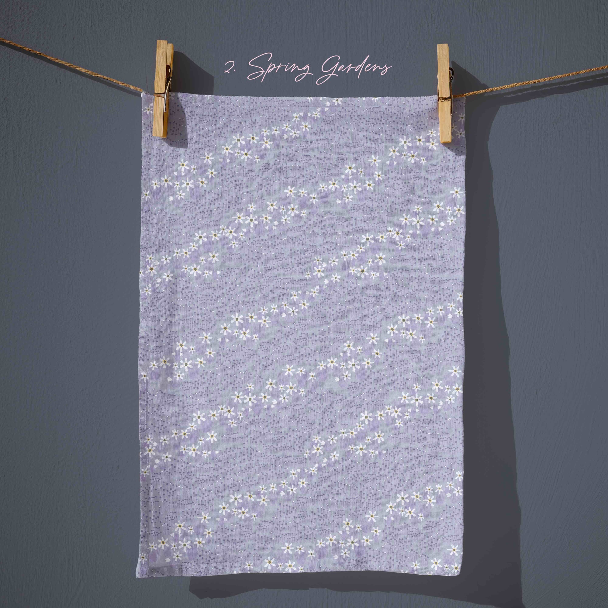 Lavender floral tea towel with delicate white blossom trails and subtle speckled texture, soft pastel cottagecore kitchen decor inspired by spring evenings.