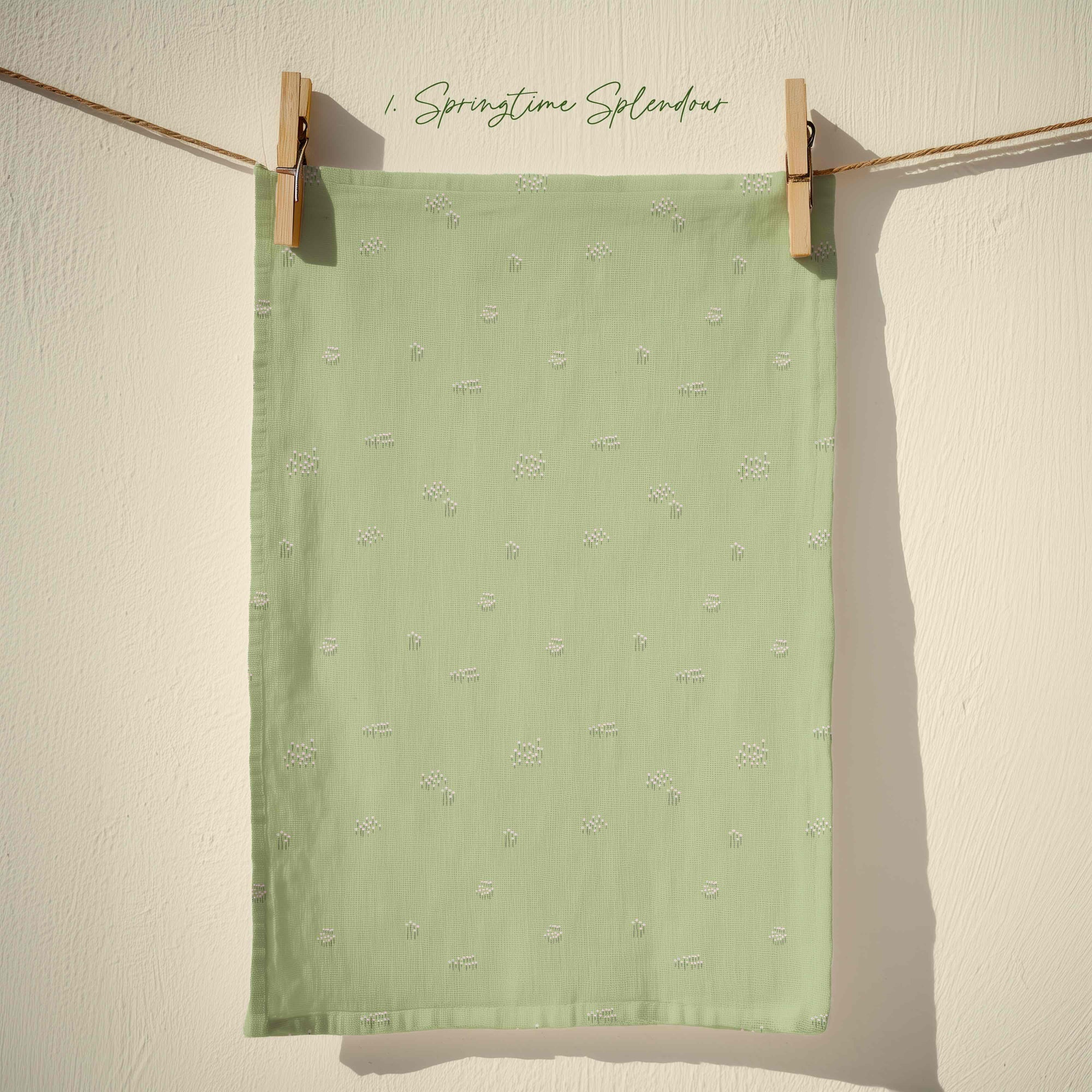 Soft sage green tea towel with delicate white ditsy floral sprig pattern inspired by English country gardens, pastel cottagecore spring kitchen decor