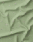 Sage green fabric with soft pink floral buds, inspired by early spring flowers in a Somerset garden